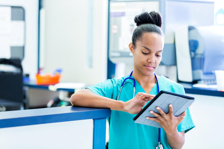 Nurse updating electronic medical record on tablet