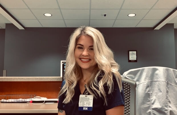 AMN Healthcare traveler, Ashley Martin, sitting at a desk