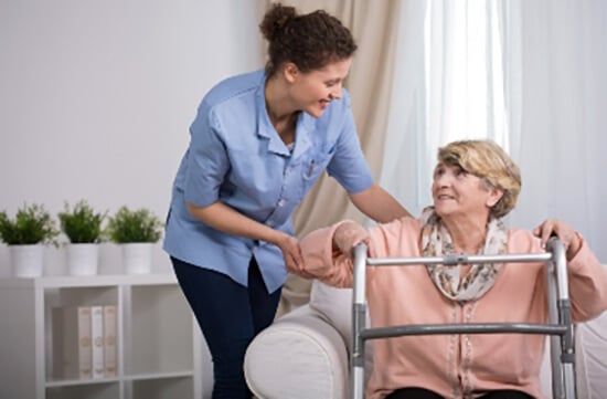 healthcare professional assisting a senior patient in her own home