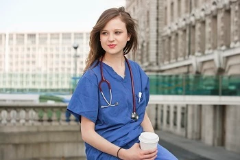 A travel nurse outside