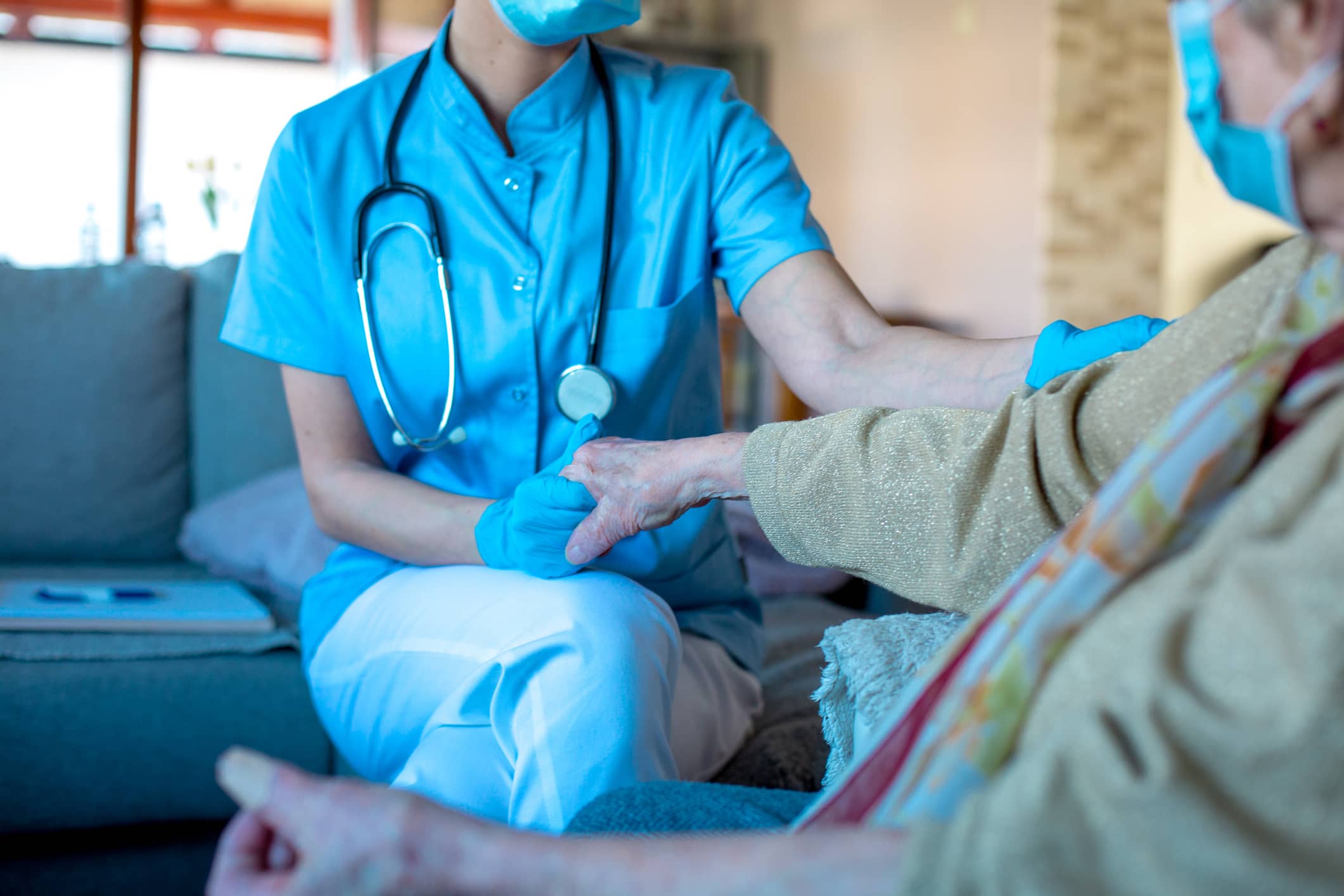 patient holding nurse's hand