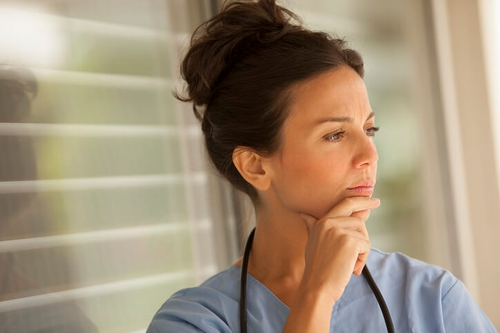 nurse looking thoughtfully away from camera
