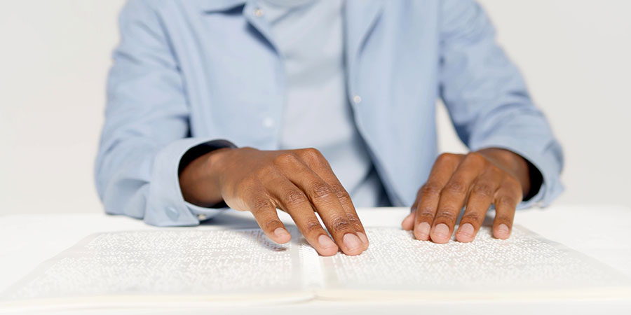 blind person reading braille blind person reading braille