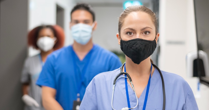 three young nurses with scrubs and masks