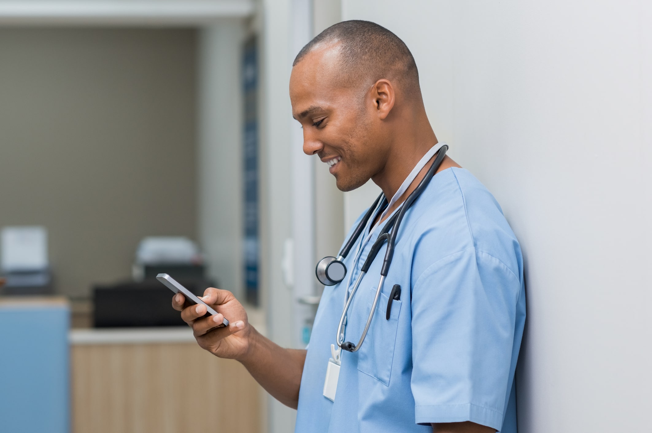 male nurse looking at cell phone