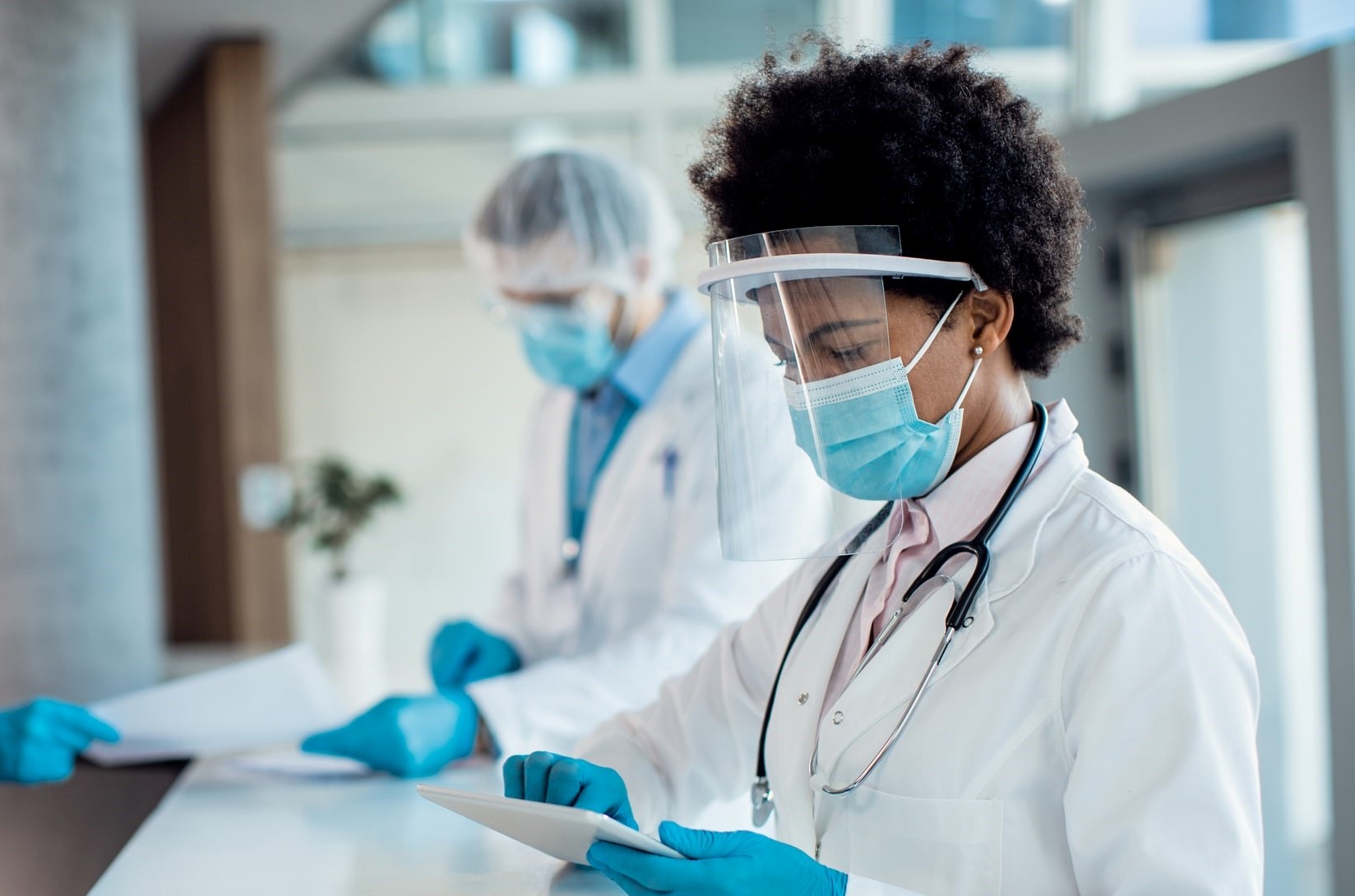 doctors working on tablets