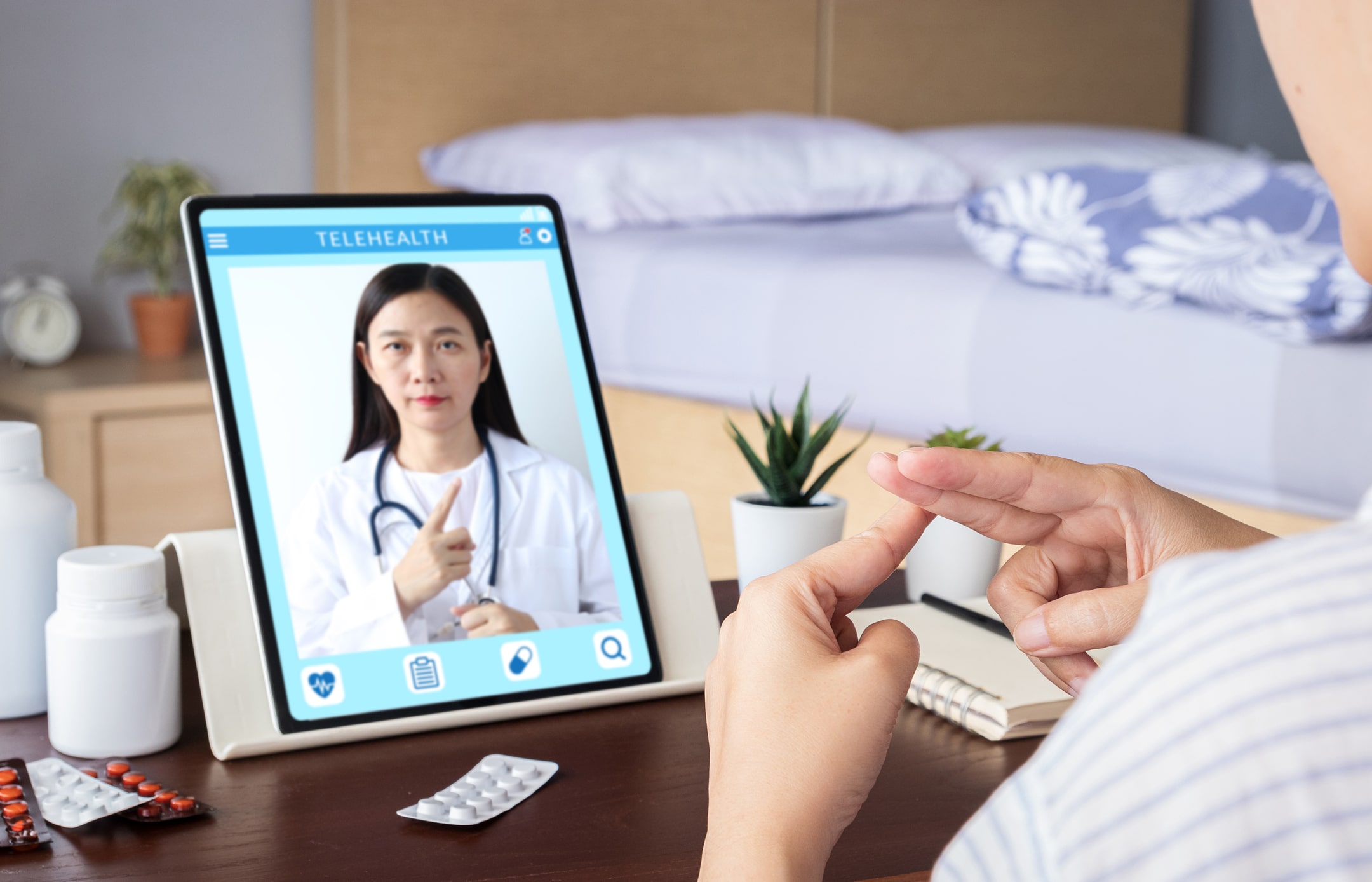 person doing teletherapy with doctor on ipad person doing teletherapy with doctor on ipad