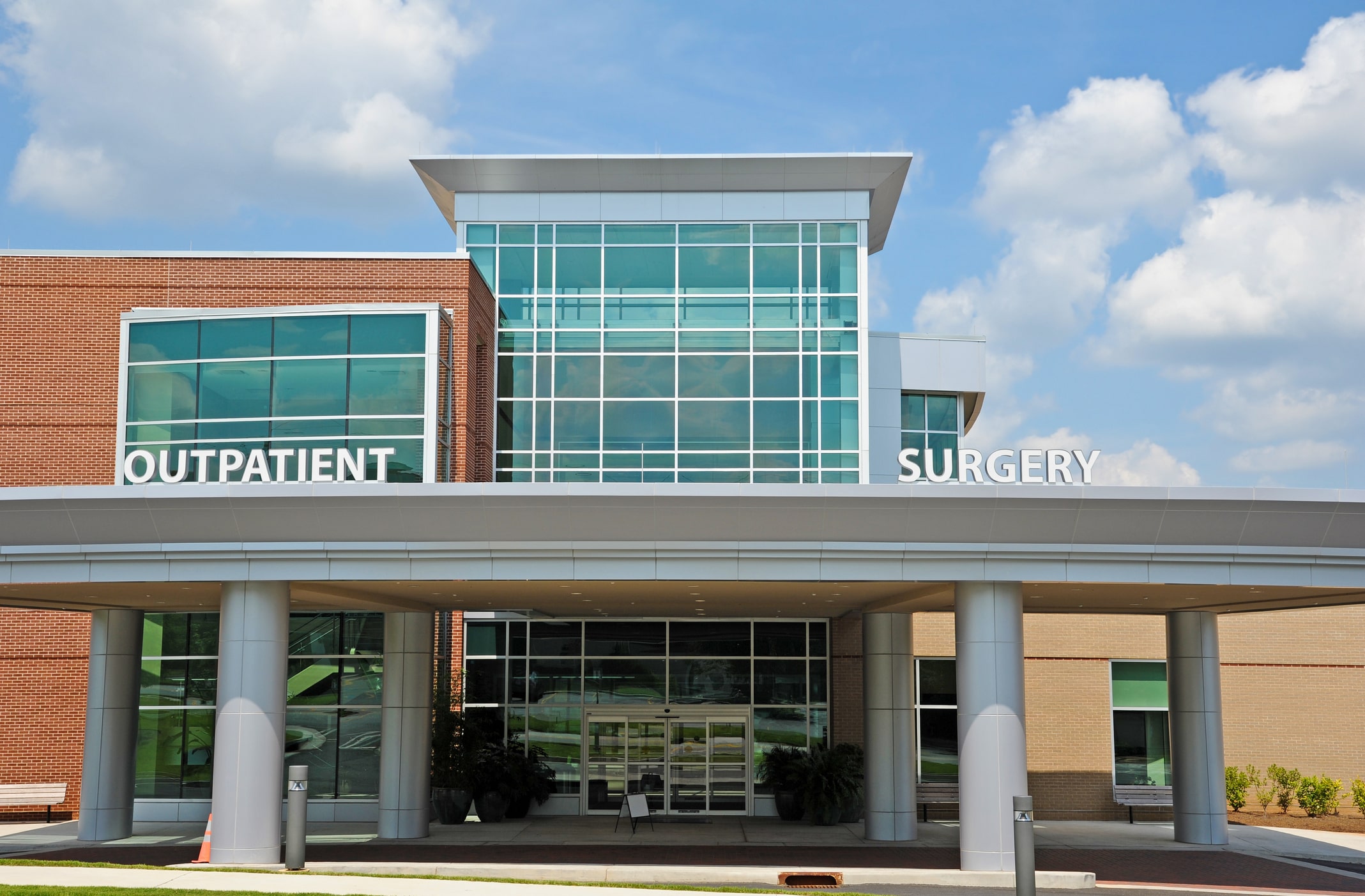 front shot of outpatient building, with blue mirror windows and red bricks front shot of outpatient building, with blue mirror windows and red bricks