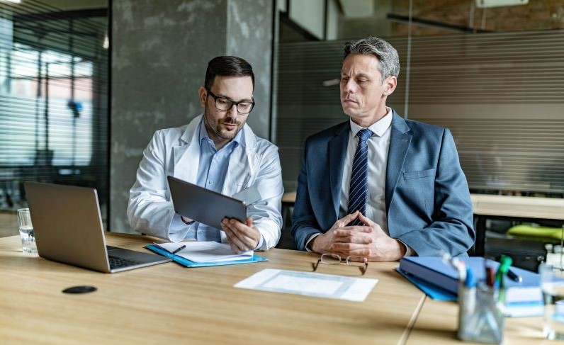 doctor and businessman discussing healthcare workforce strategies doctor and businessman discussing healthcare workforce strategies