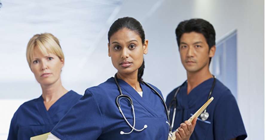 close up of three nurses with serious looks on their faces