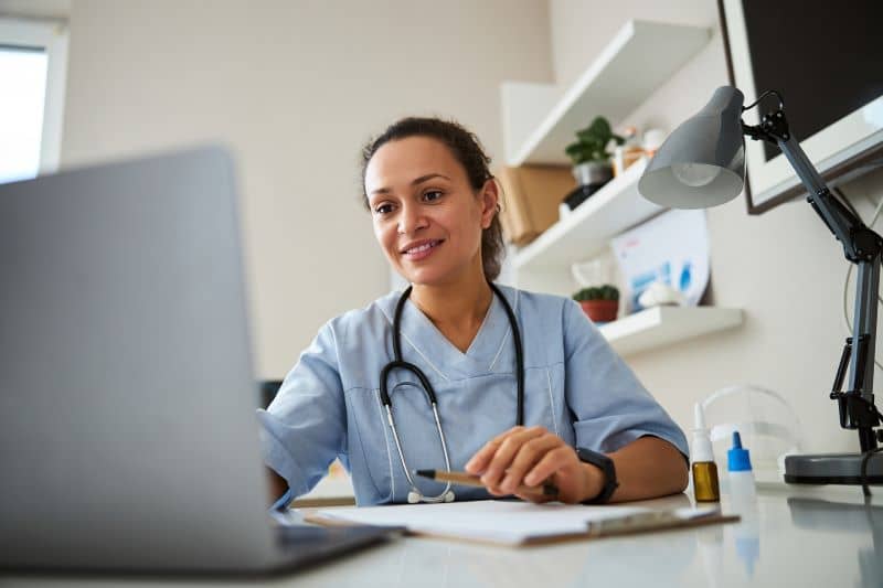 female doctor operating her laptop