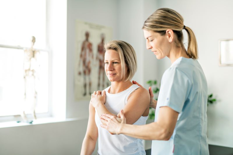 physical therapist working with patient