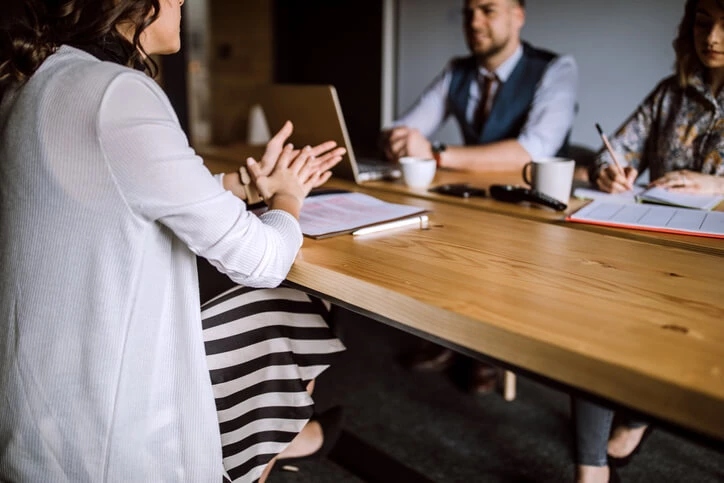 business woman having meeting with people on a table