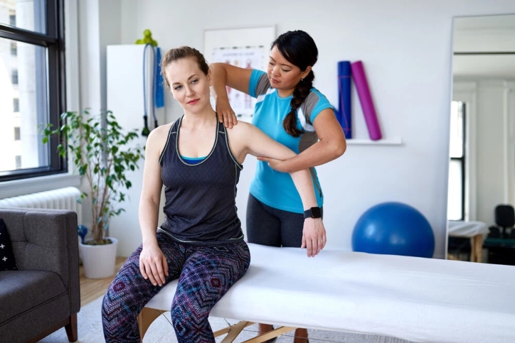 A woman receiving a massage from a physical therapist