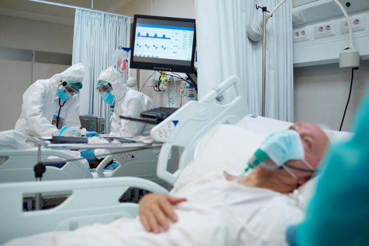 covid patients with mask and breathing machine