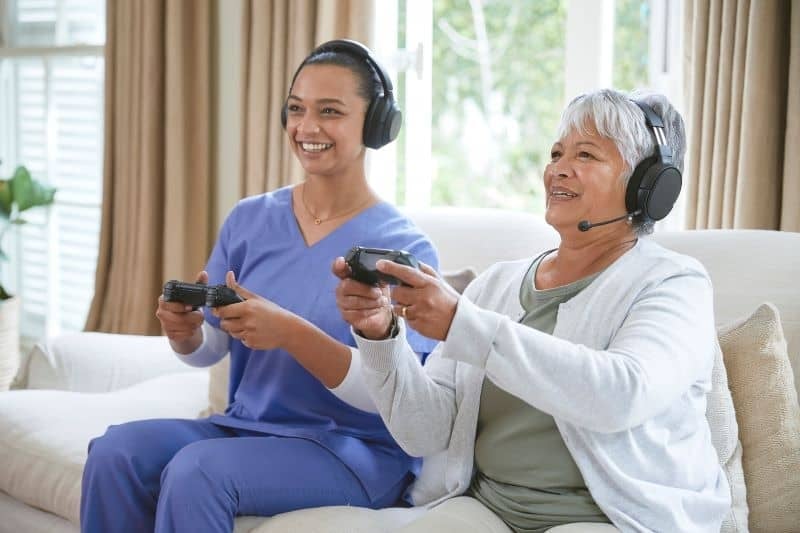 Nurse with patient playing video games