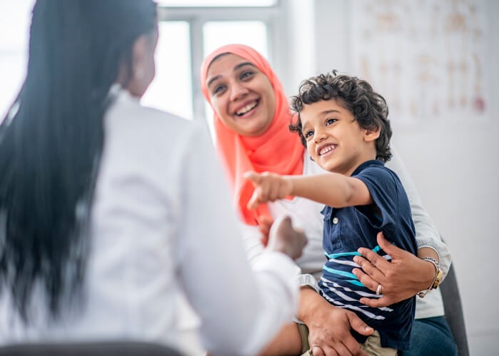 mother and son talking to healthcare professional