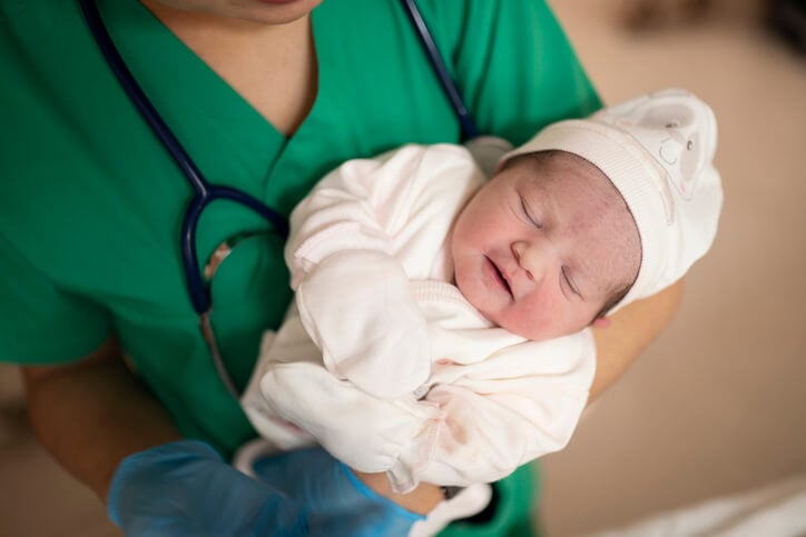 nurse holding new born baby