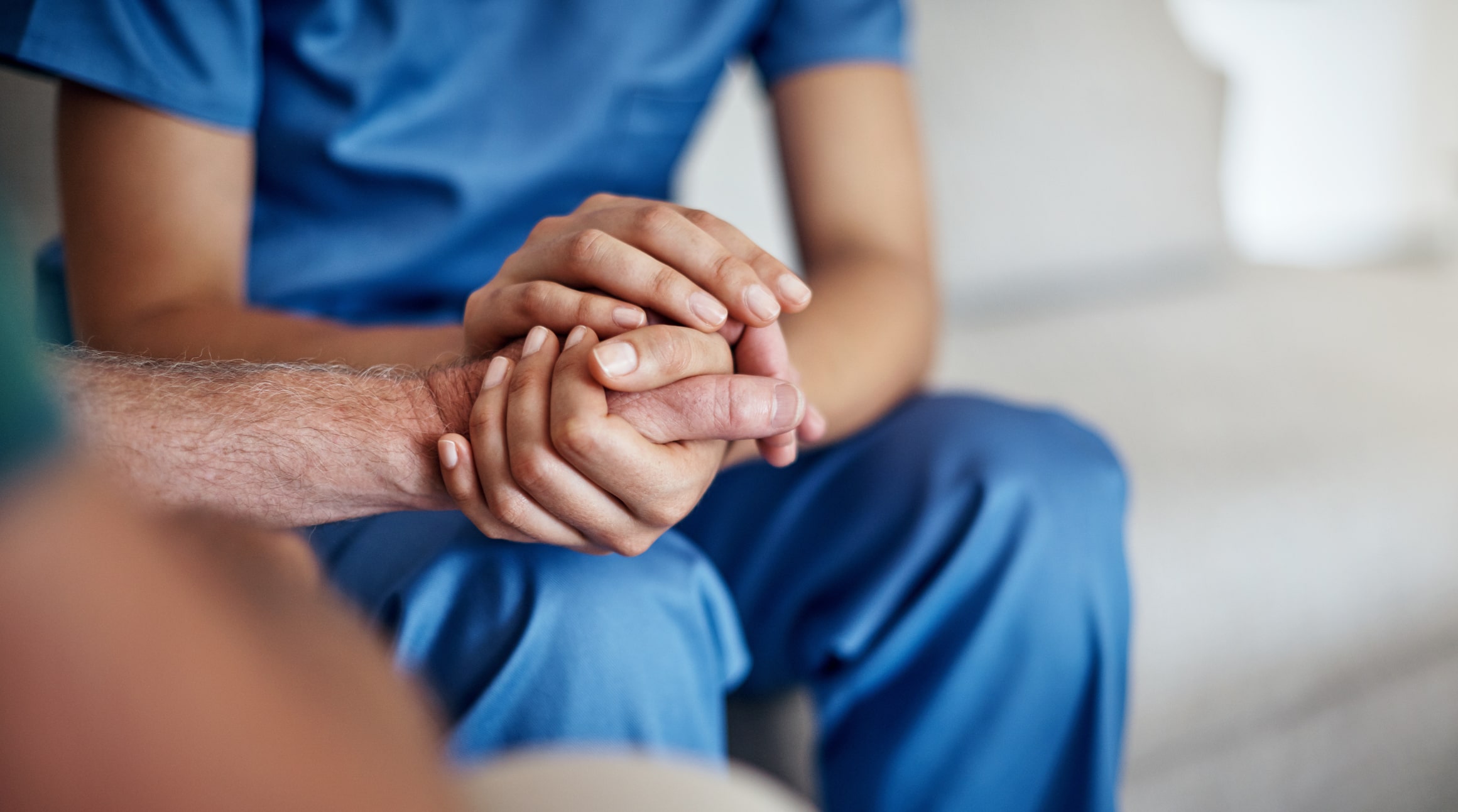 Nurse holding patient's hand