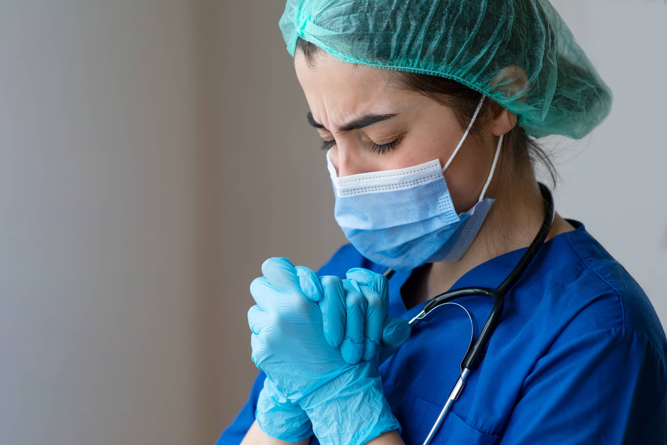 travel nurse in scrubs, a mask , and gloves