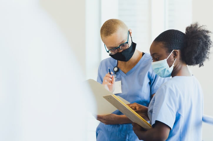 two nurses looking at a chart