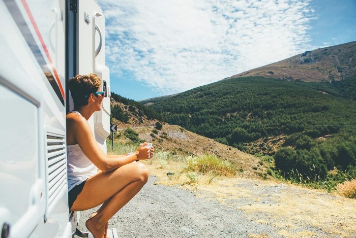 travel nurse sitting on the step of her trailer