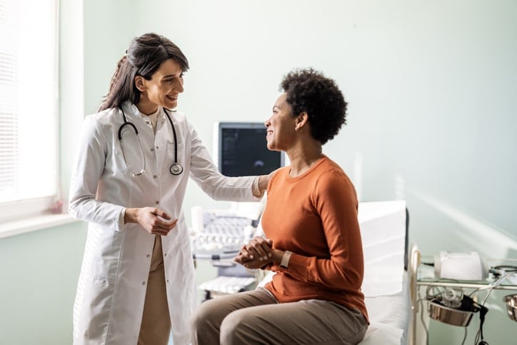 physician smiling with a patient