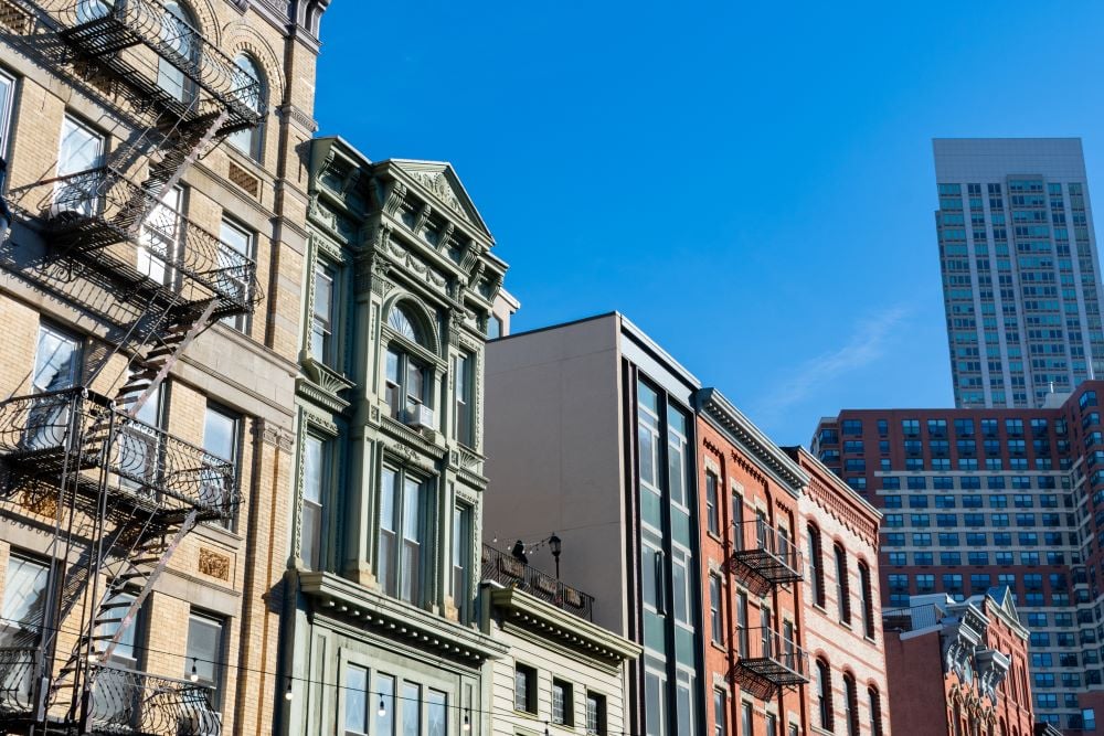 An apartment building overlooking a cityscape background