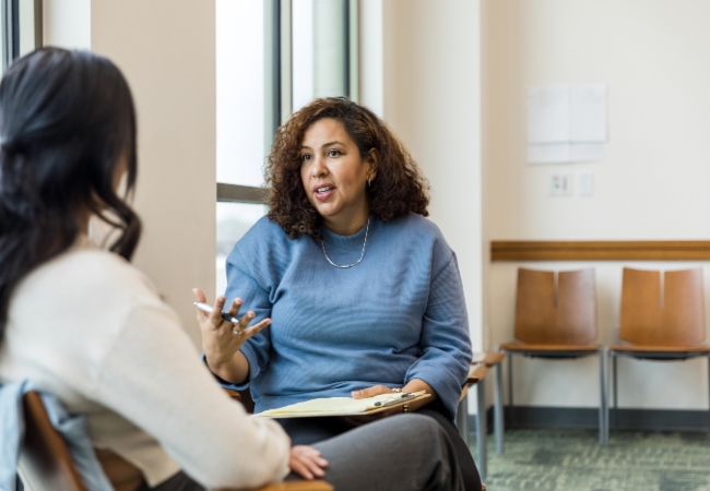 Therapist speaking with female patient