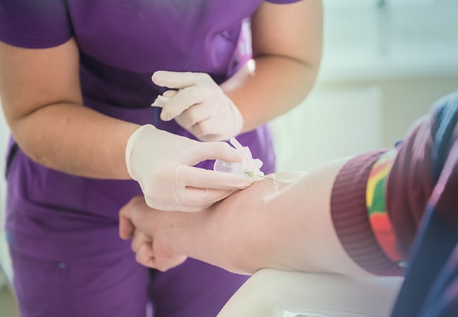 Nurse drawing blood from patient