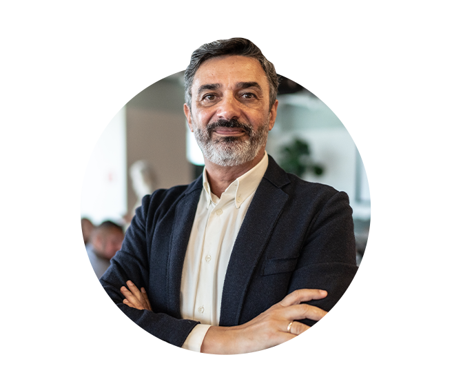 Male executive of company standing arms crossed. 