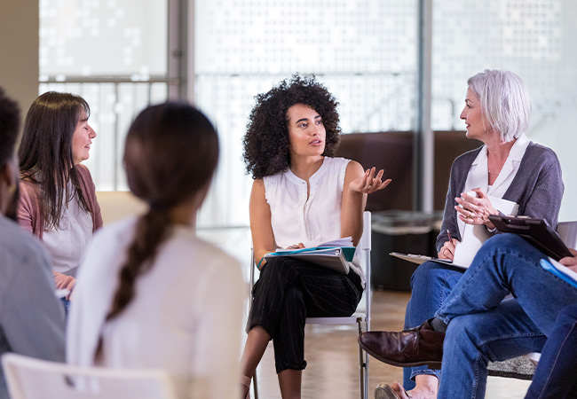 Woman speaking in group meeting