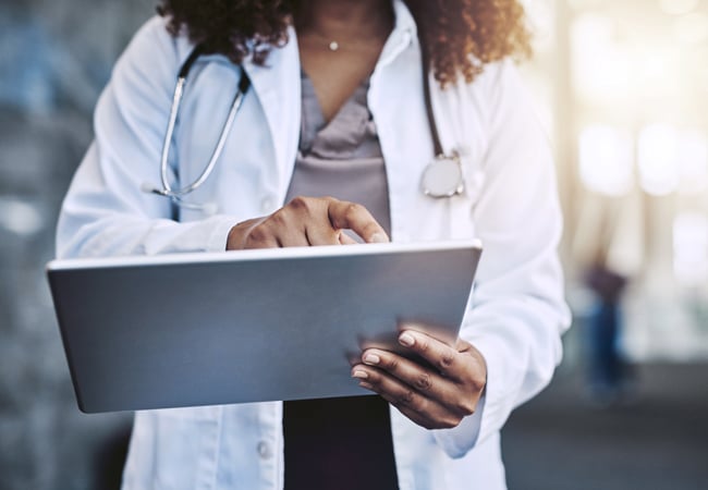 Physician using tablet computer Physician using tablet computer